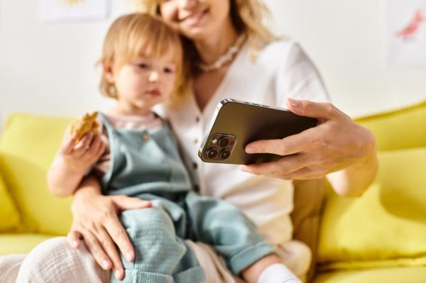 A mother allows her child to watch a Smartphone.